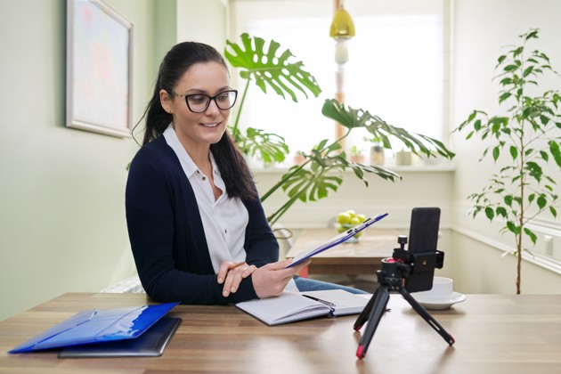 Business Woman Looking Into Smartphone Webcam